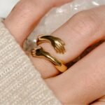 Golden Embrace Hugging Hands Ring